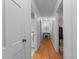 Bright hallway with hardwood floors, connecting various rooms in the home at 310 Edward Ln, Louisburg, NC 27549