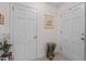 Entry hallway featuring tile floor, neutral wall paint, and simple wall decor at 310 Edward Ln, Louisburg, NC 27549