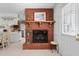 Cozy living room with a brick fireplace and a view of the kitchen at 310 Edward Ln, Louisburg, NC 27549