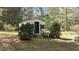 Charming shed with new exterior and landscaped with hedges. Fresh paint and stylish door at 310 Edward Ln, Louisburg, NC 27549