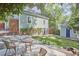 A charming backyard with a patio, lawn, and a small storage shed, perfect for outdoor living at 315 Greenwood Dr, Durham, NC 27704