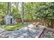 Backyard with an outdoor shed, seating area, and lush foliage at 315 Greenwood Dr, Durham, NC 27704