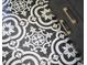 Close-up of the bathroom floor with black and white patterned tiles next to a black vanity at 315 Greenwood Dr, Durham, NC 27704