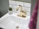 Modern bathroom vanity features a white sink, gold faucet, and stylish decor create a luxurious space at 315 Greenwood Dr, Durham, NC 27704