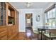 Charming dining area features hardwood floors, modern lighting, and a built-in wooden china cabinet for elegant storage at 315 Greenwood Dr, Durham, NC 27704