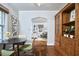 Charming dining area with hardwood floors, featuring a view into a living room with built-in bookshelves at 315 Greenwood Dr, Durham, NC 27704