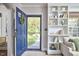 Inviting foyer with an open blue front door and built-in shelving, creating a warm and stylish entrance at 315 Greenwood Dr, Durham, NC 27704