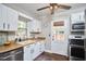 Bright kitchen with white cabinetry, stainless steel appliances, butcher block counters, and tiled floors offers a functional design at 315 Greenwood Dr, Durham, NC 27704