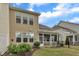 Backyard with a screened-in porch, well-maintained lawn, lush landscaping, and a fenced-in area at 318 Acorn Hollow Pl, Durham, NC 27703