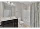 Bathroom with a dark wood vanity, tiled floors, and shower tub at 318 Acorn Hollow Pl, Durham, NC 27703