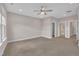 Spacious bedroom with a ceiling fan, carpet flooring, and neutral walls at 318 Acorn Hollow Pl, Durham, NC 27703