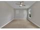 Spacious bedroom with plush carpet, neutral walls, and a ceiling fan at 318 Acorn Hollow Pl, Durham, NC 27703