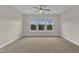 Large bedroom featuring plush carpeting, ceiling fan, and many windows at 318 Acorn Hollow Pl, Durham, NC 27703