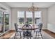 Cozy dining area featuring a chandelier, a wooden table with chairs, and lots of natural light at 318 Acorn Hollow Pl, Durham, NC 27703