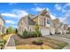 Charming townhouse with well maintained landscaping and a two-car garage, creating curb appeal at 318 Acorn Hollow Pl, Durham, NC 27703