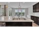 Bright kitchen featuring a large island with a sink, pendant lighting, and modern finishes at 318 Acorn Hollow Pl, Durham, NC 27703