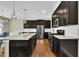 Kitchen featuring stainless steel appliances, a breakfast bar, and sleek dark cabinets at 318 Acorn Hollow Pl, Durham, NC 27703