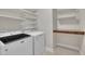 Laundry room featuring white appliances and shelving for storage at 318 Acorn Hollow Pl, Durham, NC 27703