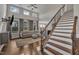 Bright living room with staircase, hardwood floors, many windows and high ceilings at 318 Acorn Hollow Pl, Durham, NC 27703