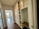 Mudroom featuring built-in storage cabinets, shelving, and coat hooks at 318 Acorn Hollow Pl, Durham, NC 27703