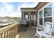 Back deck with a grill and a rocking chair overlooking the neighborhood at 3262 Ripley River Rd, New Hill, NC 27562