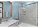 Bathroom featuring a walk-in shower with glass doors and a white vanity with modern fixtures at 3262 Ripley River Rd, New Hill, NC 27562