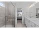 Contemporary bathroom boasts a glass shower enclosure and double sink vanity, seamlessly connecting to the Primary bedroom at 3262 Ripley River Rd, New Hill, NC 27562