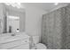Bright bathroom features a single sink vanity with a shower and tub combination at 3262 Ripley River Rd, New Hill, NC 27562