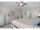 Spacious bedroom with a comfortable bed, dresser, and large window providing ample natural light, enhancing the airy feel at 3262 Ripley River Rd, New Hill, NC 27562