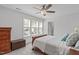 This main bedroom includes a ceiling fan, and light gray walls at 3262 Ripley River Rd, New Hill, NC 27562