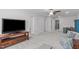 A light gray bonus room with a flat screen TV, comfortable seating, and bright light at 3262 Ripley River Rd, New Hill, NC 27562