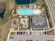 Aerial view of the community pool, playground, and clubhouse with ample parking and lounge seating at 3262 Ripley River Rd, New Hill, NC 27562