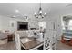 Open dining area adjacent to living room, featuring chandelier and seating for six guests at 3262 Ripley River Rd, New Hill, NC 27562