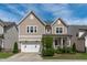 Charming two-story home featuring a covered front porch, two-car garage, and well-maintained landscaping at 3262 Ripley River Rd, New Hill, NC 27562