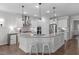 Bright kitchen with granite countertops, stainless steel appliances, and a central island with bar seating at 3262 Ripley River Rd, New Hill, NC 27562