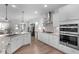 Gourmet kitchen featuring stainless steel appliances, double oven, granite countertops, and a center island at 3262 Ripley River Rd, New Hill, NC 27562