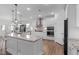 Modern kitchen with white cabinets, granite countertops, stainless steel appliances and stylish pendant lighting at 3262 Ripley River Rd, New Hill, NC 27562