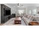Bright living room with fireplace, large windows, and comfortable seating area at 3262 Ripley River Rd, New Hill, NC 27562