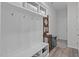 Mudroom boasts coat hooks, a bench, and shelving for convenient storage at 3262 Ripley River Rd, New Hill, NC 27562
