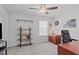 Bright office with ceiling fan, light gray walls, dark wood desk, and shelving at 3262 Ripley River Rd, New Hill, NC 27562