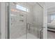 Elegant shower features a glass enclosure and convenient built-in shelves, enhanced by natural light from a transom window at 3262 Ripley River Rd, New Hill, NC 27562