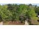 Aerial view of home surrounded by mature trees and lush landscaping at 3417 Windmere Dr, Sanford, NC 27330