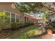 Lush backyard with patio, perfect for outdoor dining and relaxation, surrounded by mature trees at 3417 Windmere Dr, Sanford, NC 27330