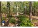 Beautiful backyard deck featuring built in seating, a swing, and wooded views at 3417 Windmere Dr, Sanford, NC 27330