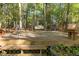 Spacious backyard deck surrounded by lush greenery and mature trees at 3417 Windmere Dr, Sanford, NC 27330