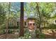 Charming backyard brick patio and pergola shaded by a canopy of trees at 3417 Windmere Dr, Sanford, NC 27330