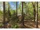 Secluded backyard patio area is surrounded by tall trees offering ample privacy at 3417 Windmere Dr, Sanford, NC 27330