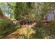 Lush backyard showcasing a mix of vibrant landscaping, a charming patio, and a storage shed at 3417 Windmere Dr, Sanford, NC 27330
