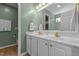 Stylish bathroom featuring double sinks, gold fixtures, and green walls at 3417 Windmere Dr, Sanford, NC 27330
