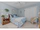 Serene bedroom with blue walls, a patterned bedspread, and a cozy wicker chair near the window at 3417 Windmere Dr, Sanford, NC 27330